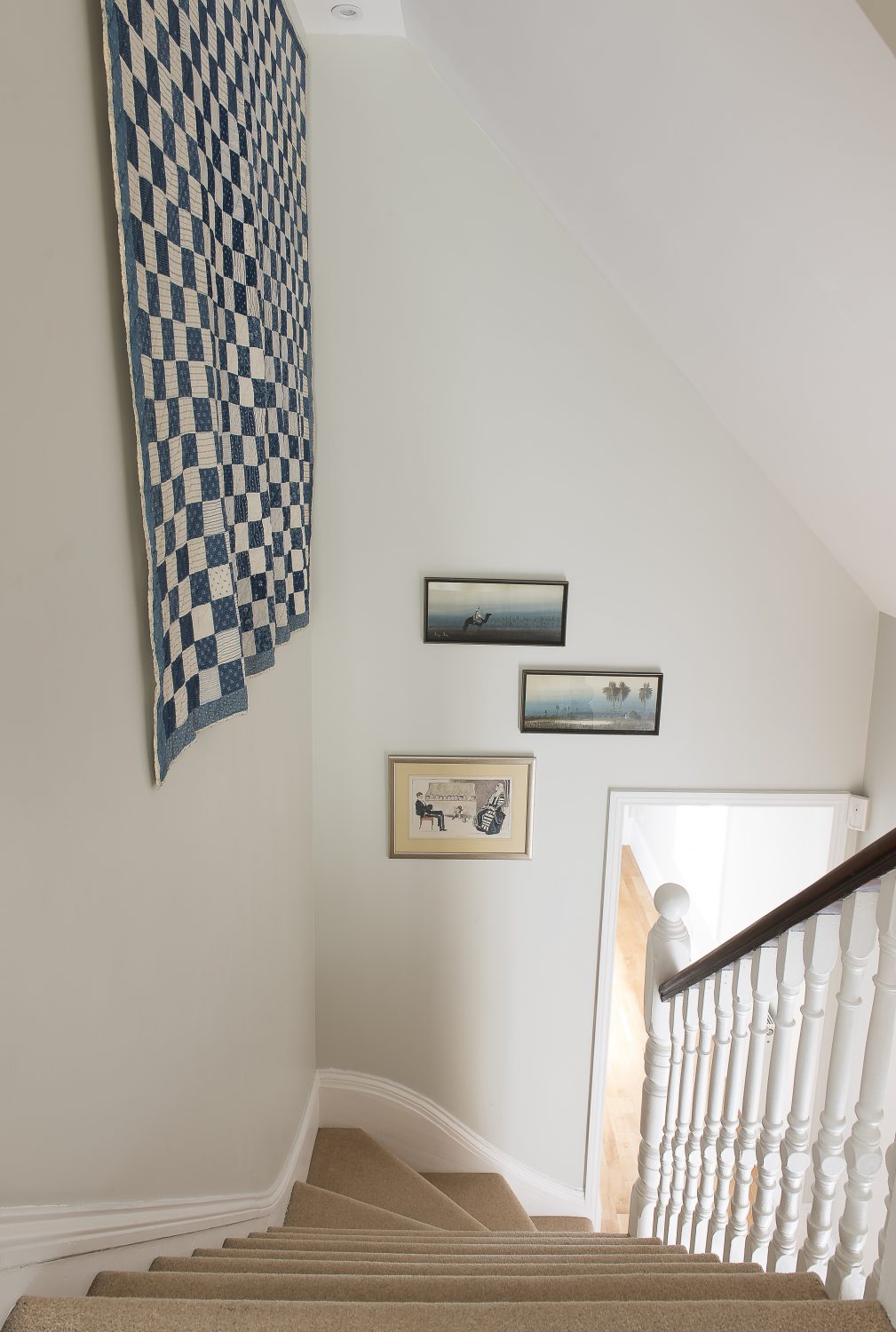 a beautiful American blue and white antique patchwork quilt which belonged to Owner Two’s mother, hanging on the wall – where you can admire every tiny precise stitch as you pass