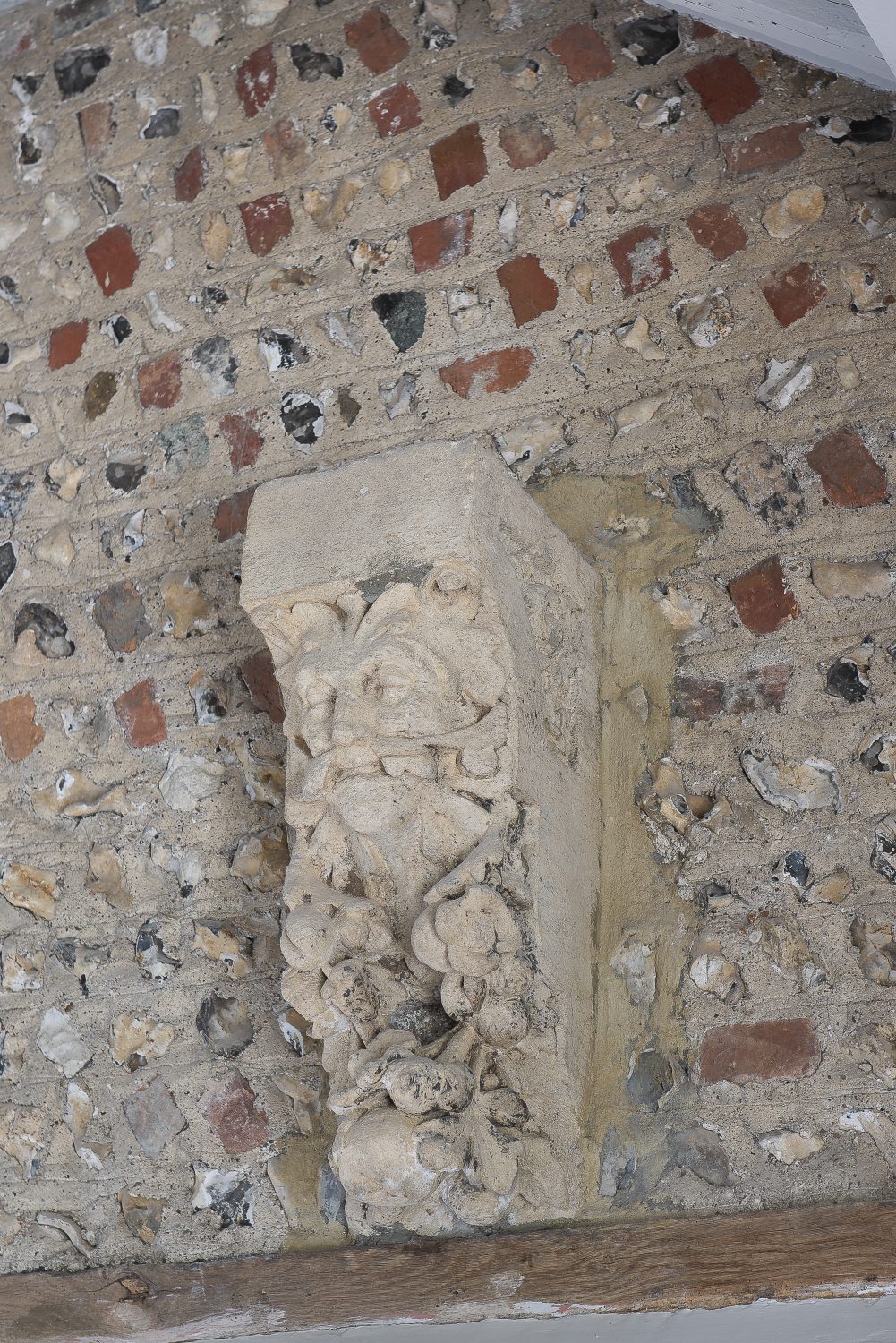 A carved stone corbel is an interesting addition to the barn’s original flint and brick walls