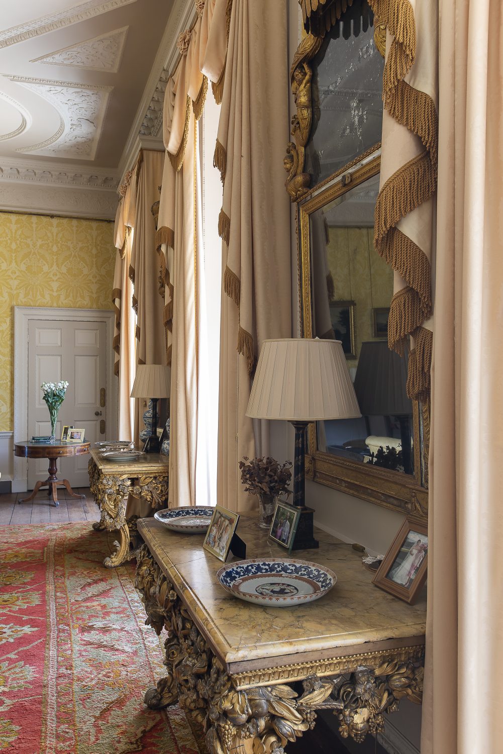 The drawing room was beautifully decorated by Henry’s mother Anthea with decorative wallpaper she commissioned specially. French windows take you out into the formal back garden
