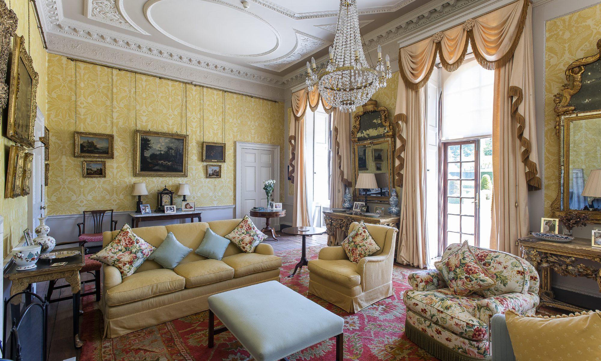 The drawing room was beautifully decorated by Henry’s mother Anthea with decorative wallpaper she commissioned specially. French windows take you out into the formal back garden