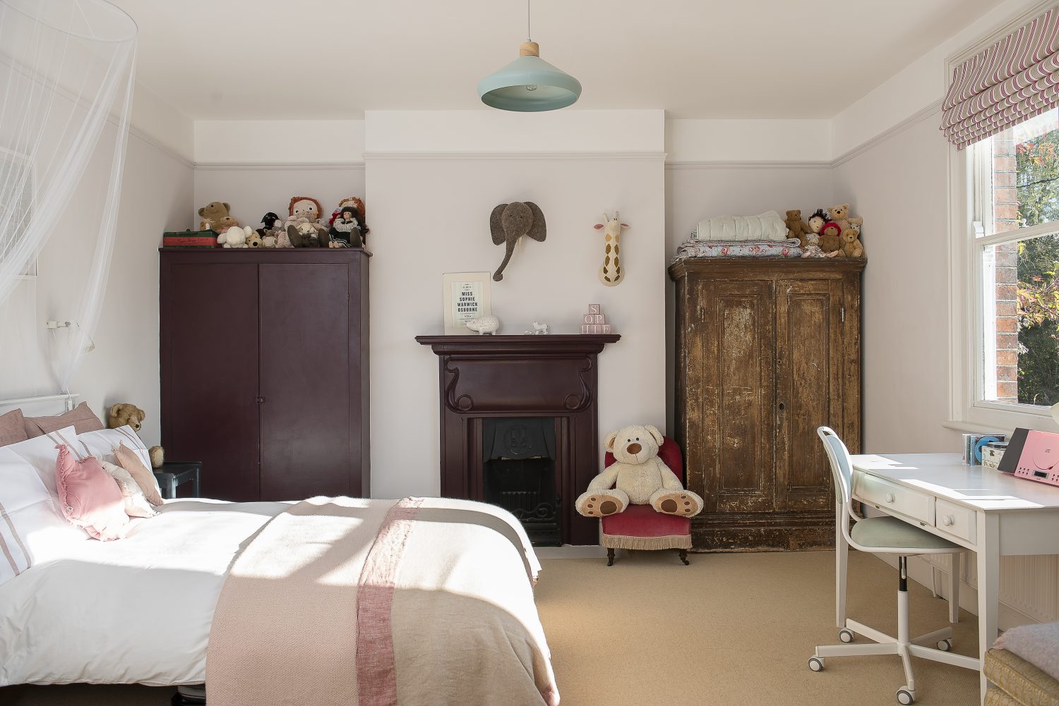 Toby and Megan’s daughter’s room has a built-in wardrobe and an original Arts and Crafts fireplace. Both are painted in Farrow & Ball’s Brinjal, which works beautifully with the soft pinks in this delightful bedroom