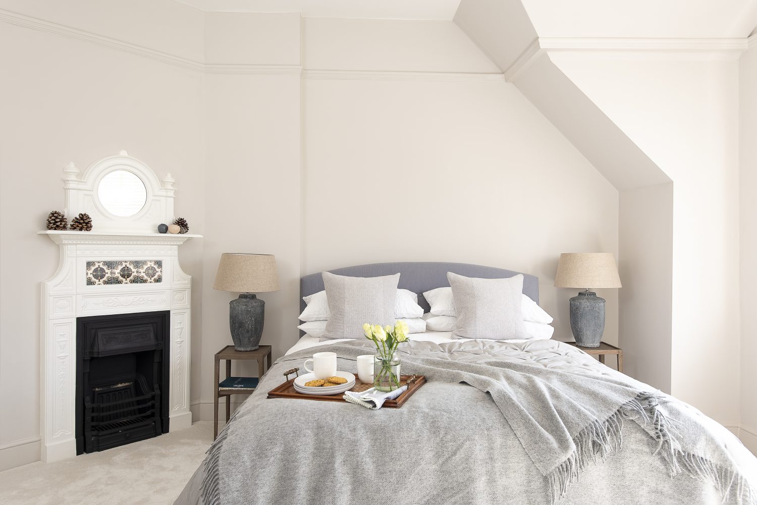 Slate grey bedside lamps from Mark Maynard complement the chair in this relaxing guest bedroom