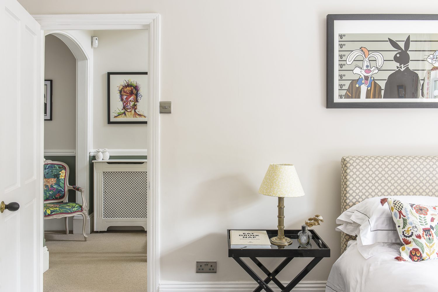 The guest bedroom is a calm haven, with walls painted in Farrow & Ball Strong White and a pleasing mix of fabric designs and colours provided by the upholstered headboard, soft furnishings and lampshades made by Jules – proving that pattern doesn’t always have to match