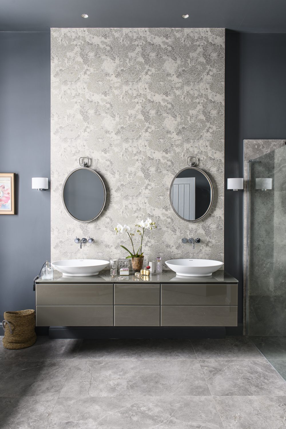 A luxurious, sculptural bath from C P Hart in Tunbridge Wells reclines next to the curtain-less window in the bathroom. The walls are painted in Scree by Little Greene, with wallpaper by Designers Guild
