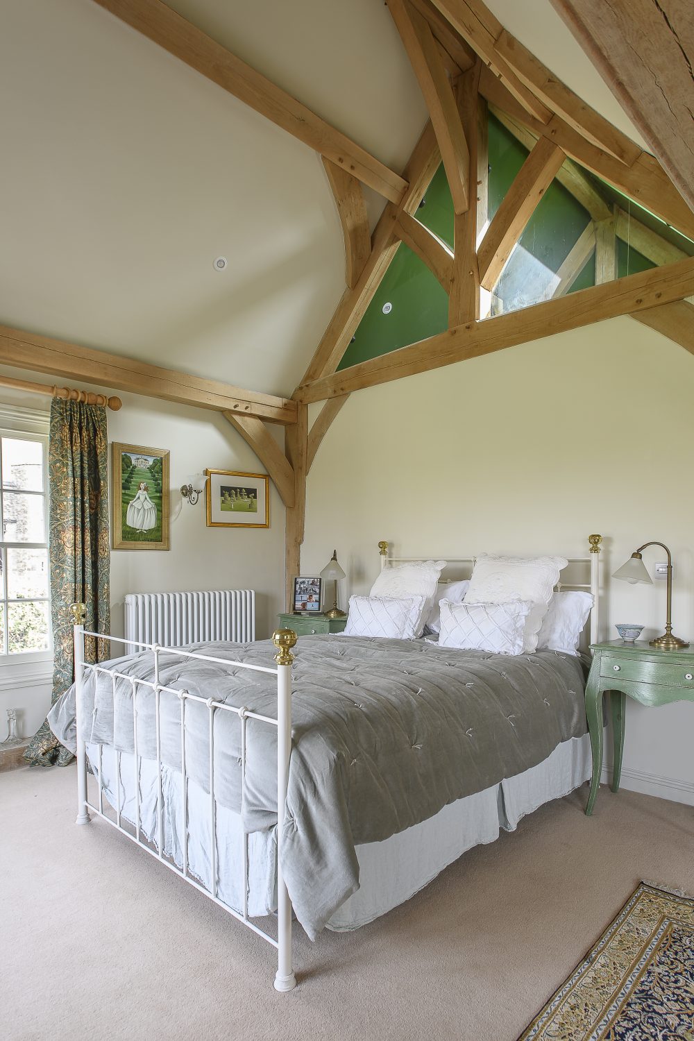 The master bedroom is situated in the two storey extension that Tim and Eve added to the house. The oak frame was made by Paul Cresswell from Sackville Oak Frames, taking around nine weeks to construct in his Kentish workshop, but just three days to install on site