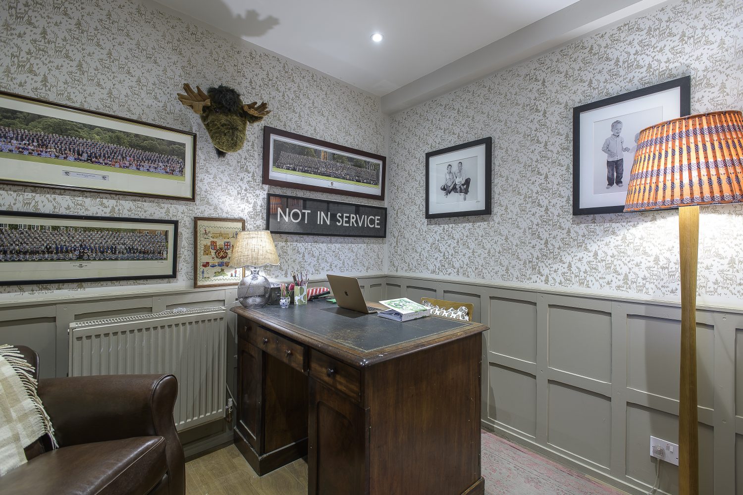 What was once the entrance to the house is now an office, with panelling painted in Farrow & Ball’s London Stone, and hand-stencilled wallpaper