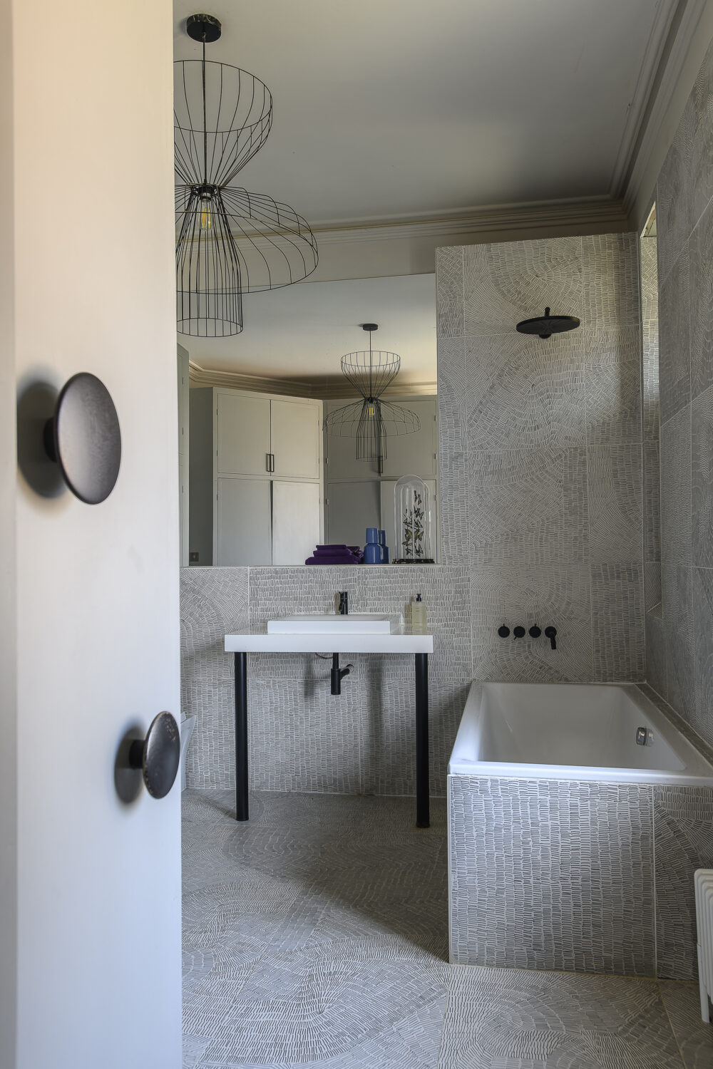 The boys’ spaces are designed for play and comfort, yet retain touches of Scarlett’s eye for design like the oversized ceiling lights and Ligne Roset sofa