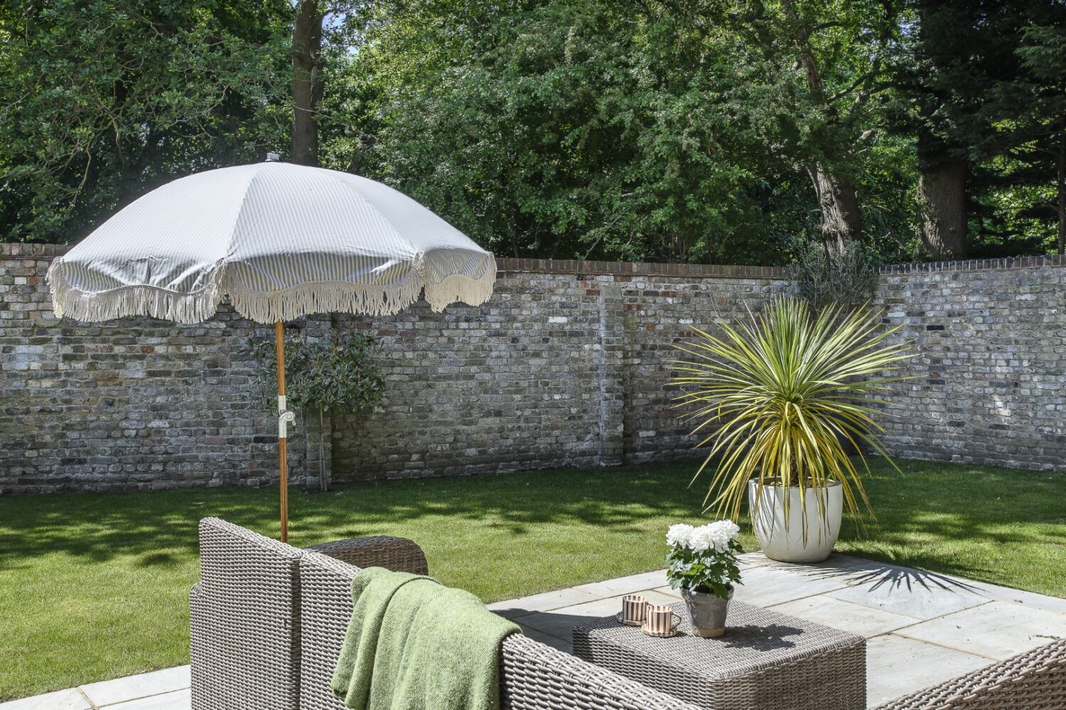 The original property’s wall is a striking focal point in the garden