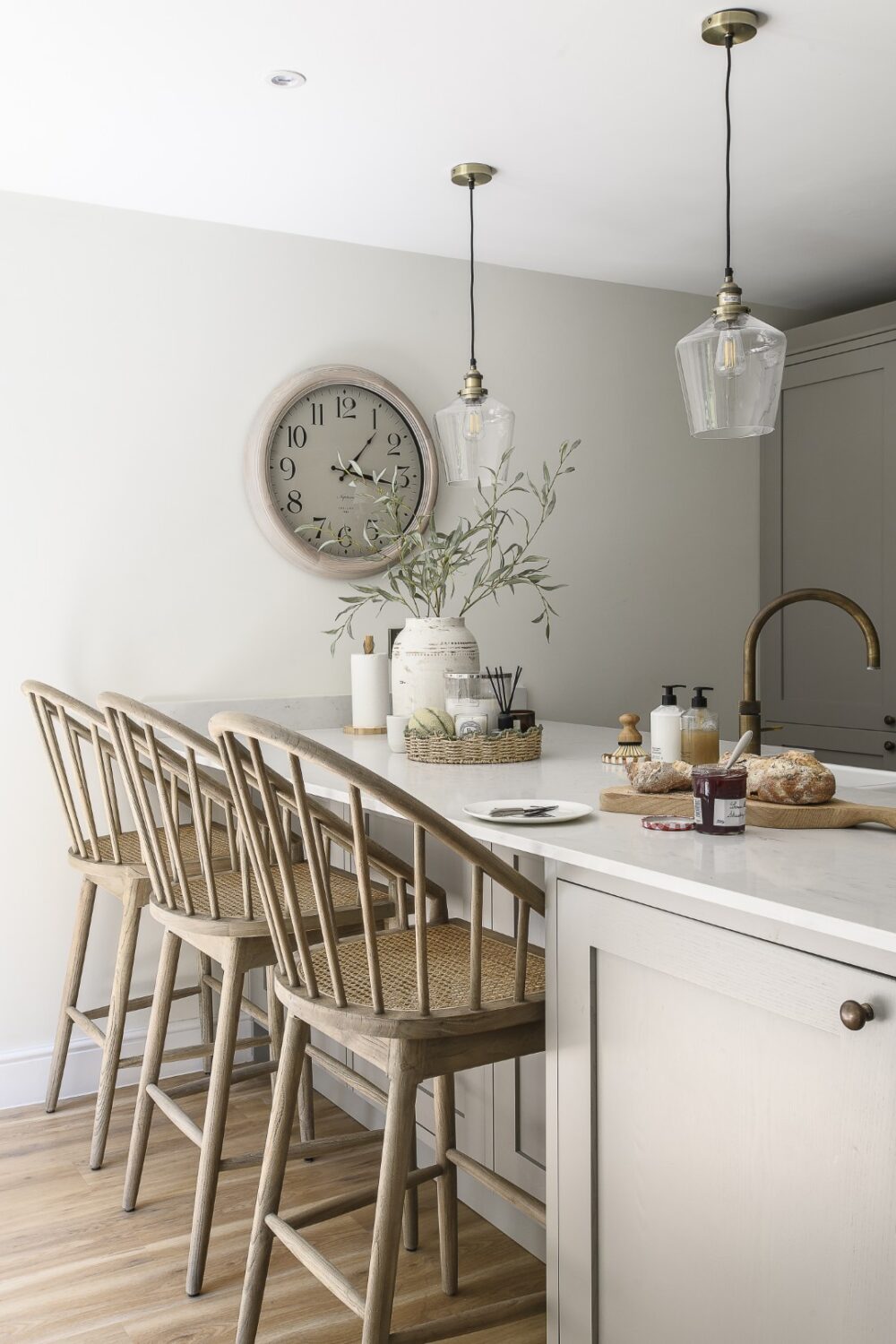 Inviting Oka bar stools and cushions draw you towards the clean, uncomplicated kitchen island area. Sara specifically chose stools that are a bit taller and wider than your average bar stool