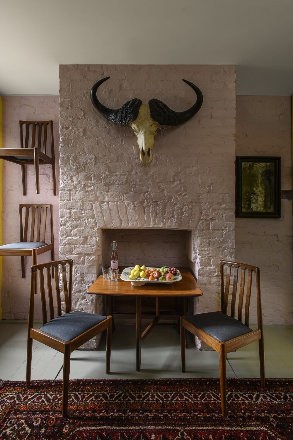 A buffalo skull above the mantelpiece was gifted in exchange for picture-framing favours,