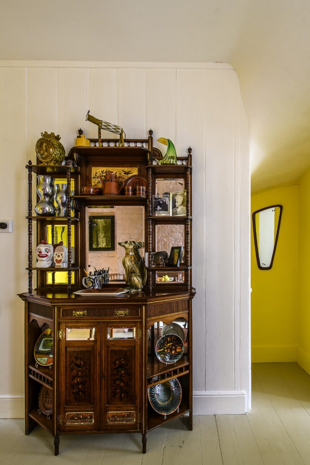 In the dining room, a tall Victorian cabinet was rescued from a film prop company.