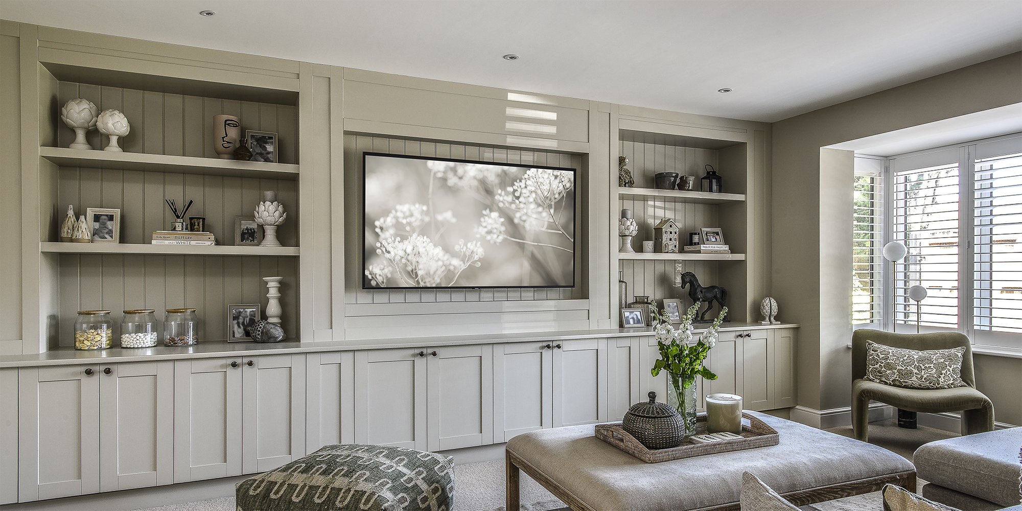 Across the hallway, which is decorated with a pretty, understated pattern rug from Charlested Home, is a more formal living room