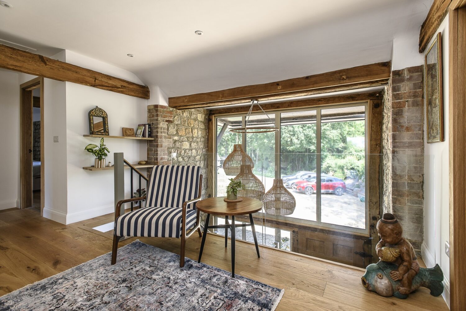 Glass balustrades let light pour into the landing from the front of the house creating an airy seating area