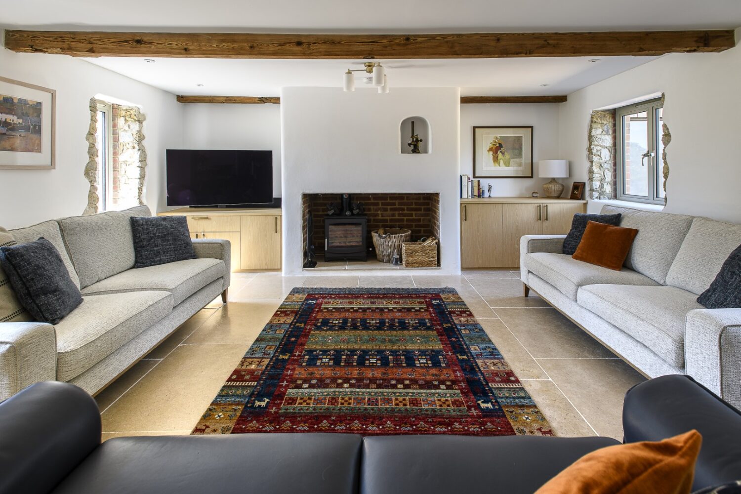 The sitting room, complete with woodburning stove and charming chimney nook, that Andrew designed to add authenticity