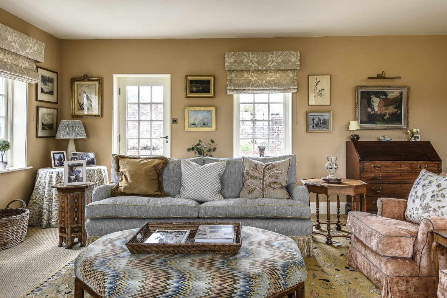 Olya softened the sitting room, a later extension, by bringing in more of a country-house feel with vintage rugs and custom covered sofas from David Seyfried