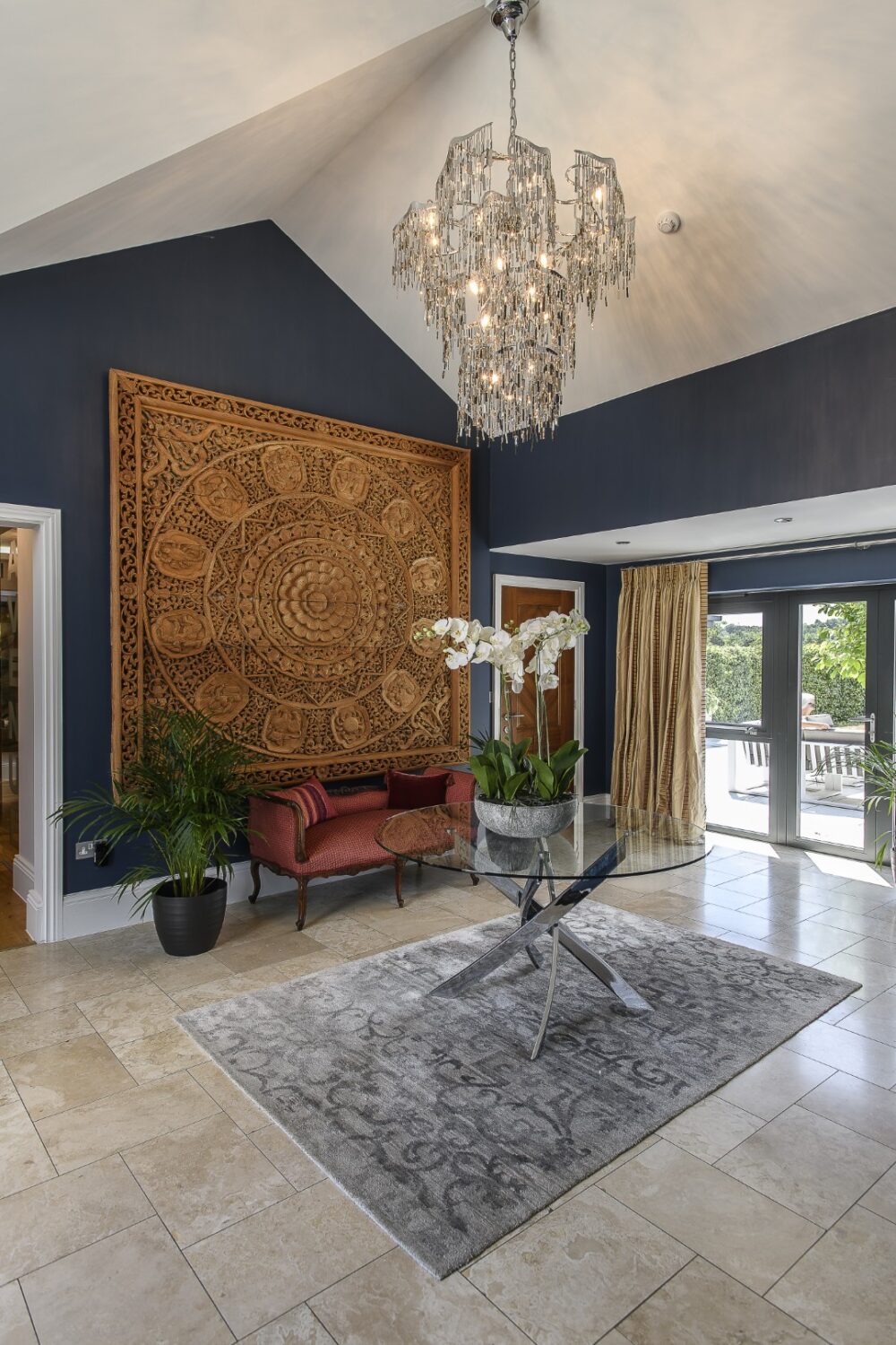 A carved wooden mandala from Thailand dominates the hallway, its concentric designs illustrating the signs of the zodiac.