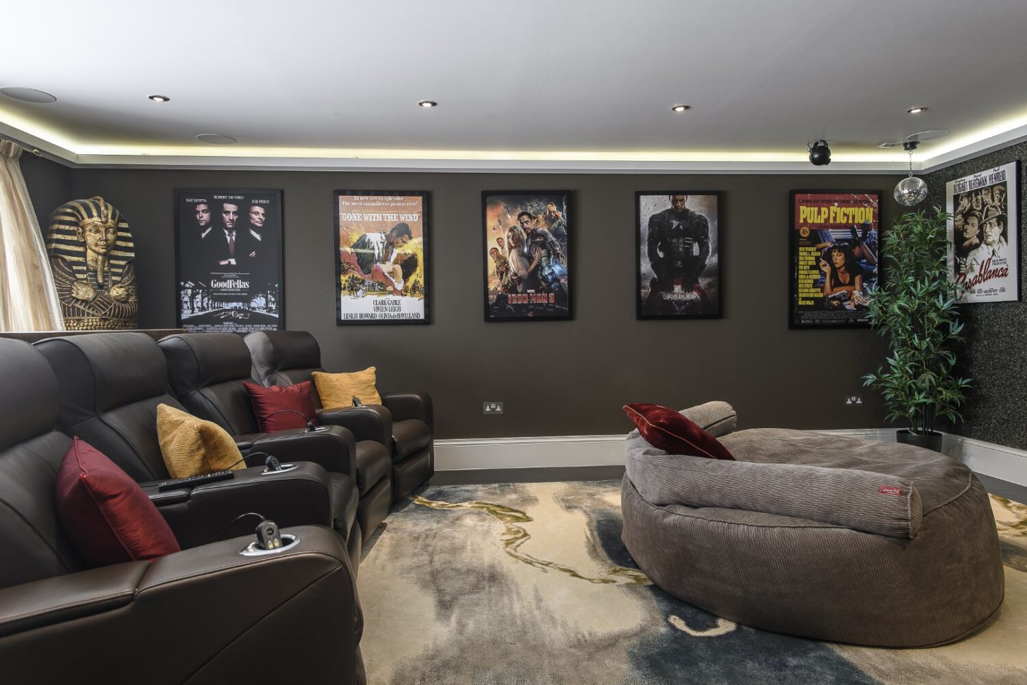 the cinema room is a family magnet: leather recliners line one side, a beanbag sprawls across the floor and a wall of classic film posters sets the tone.