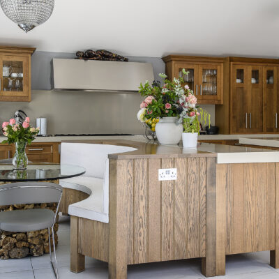 In the kitchen twin islands stretch out under glittering pendant lights, worktops provide plenty of space for cooking and huge windows connect directly to the terrace outside.