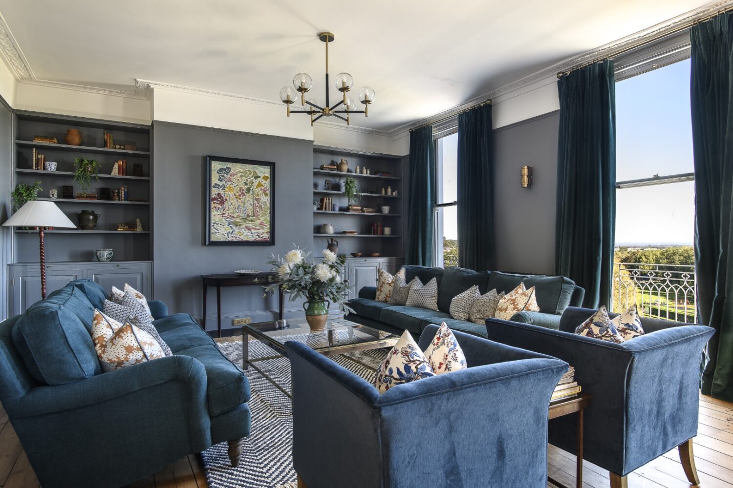 The drawing room, in shades of deep grey and navy, spans across the back of the house on the first floor and is flooded with coastal light