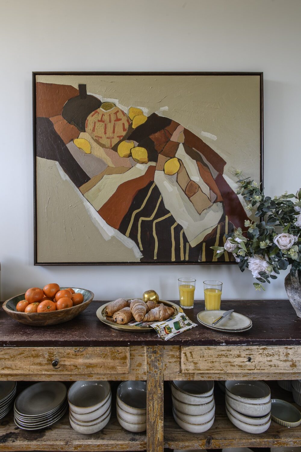 A piece by Nadia Tuercke, from McCully & Crane, hangs above a sideboard next to the dining table on the first floor
