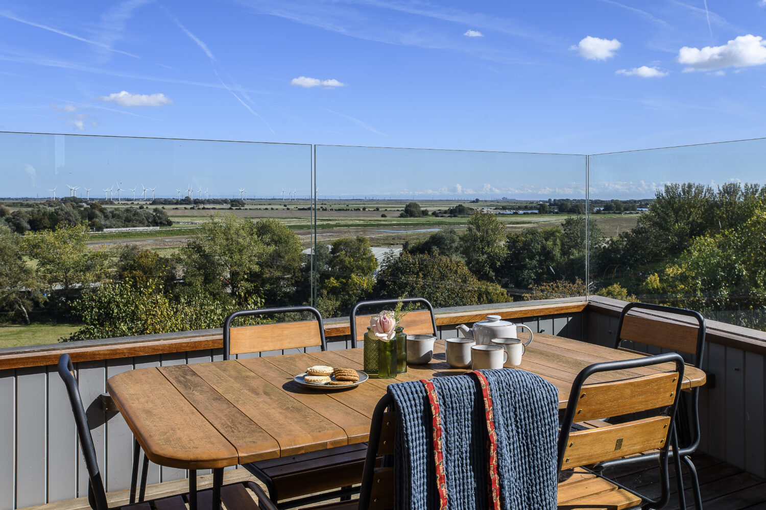 Out the back of the house, remarkable views stretch across the nature reserve all the way to Camber Sands.