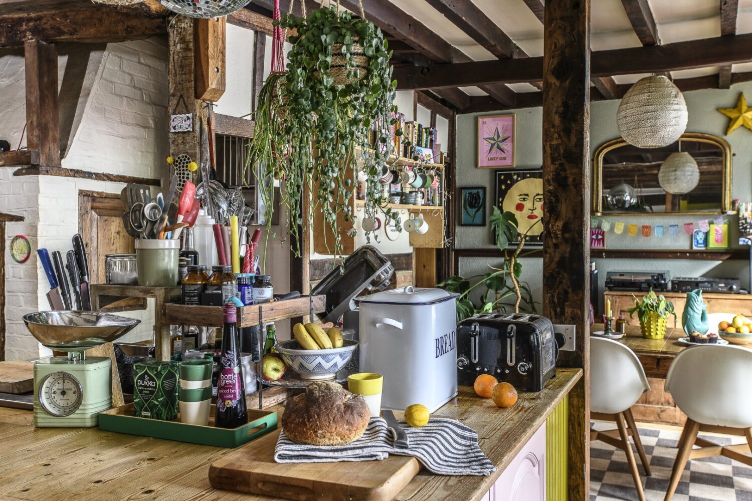 The kitchen is centred around a well-loved wooden island, filled with Kitchen Aid appliances, bottles of oils and jars of spices