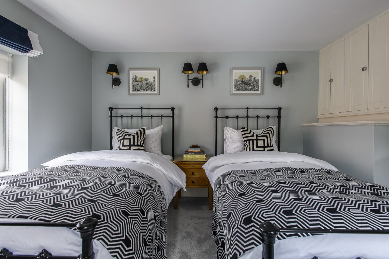 A guest room, which Sean has designed with twin beds and a whimsical faux-zebra print rug, is designed with children in mind: “It’s little whimsical, a little bit of fun,” Sean smiles