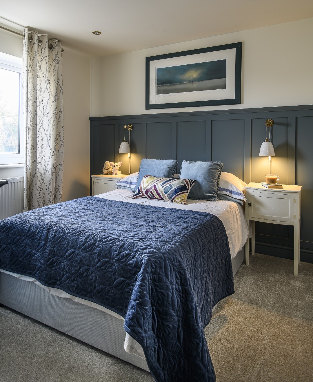 The guest bedroom is panelled and painted in Farrow & Ball De Nimes, a deep French blue