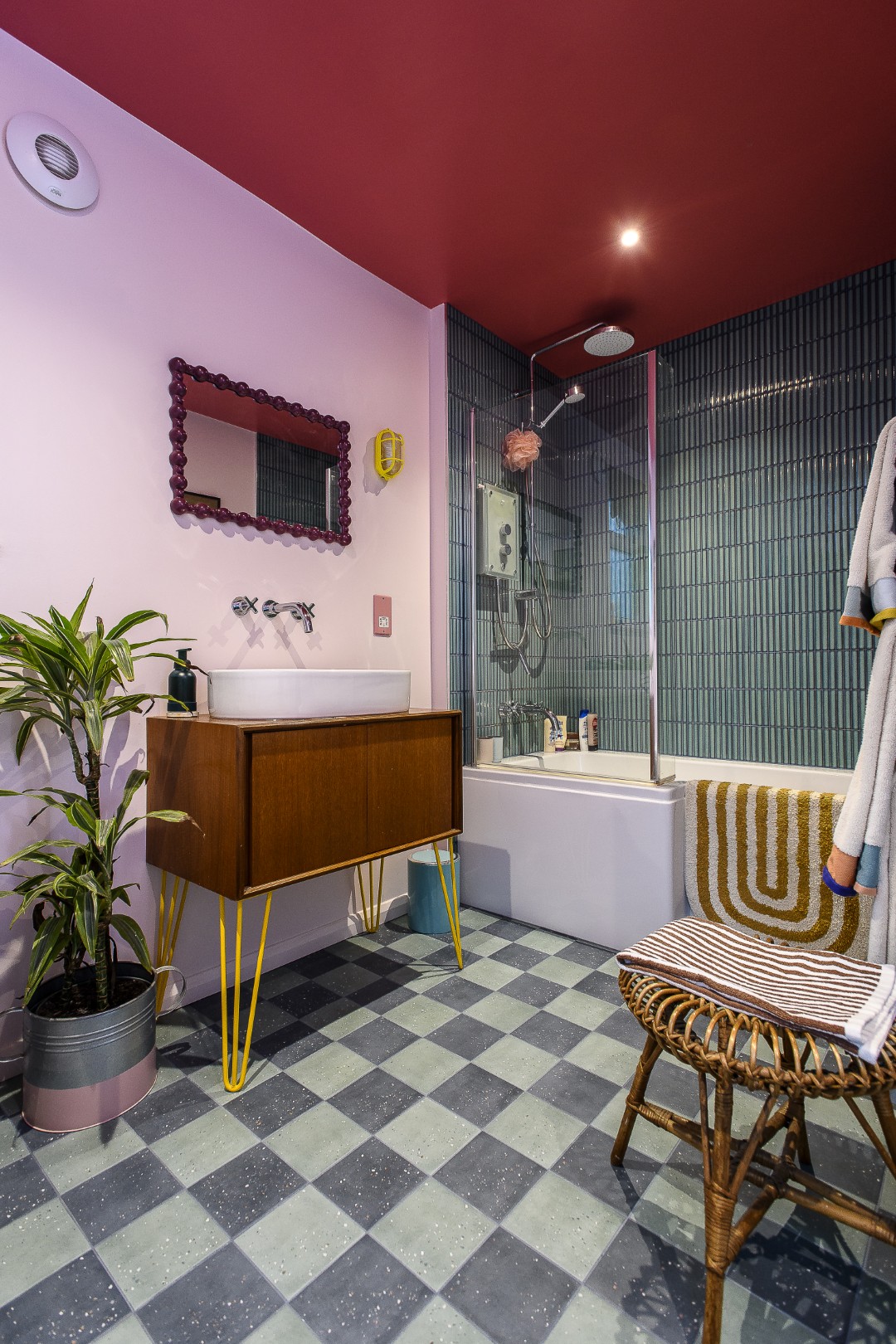 The family bathroom features Mustard Made lockers, one in a rich berry colour which is echoed on the ceiling