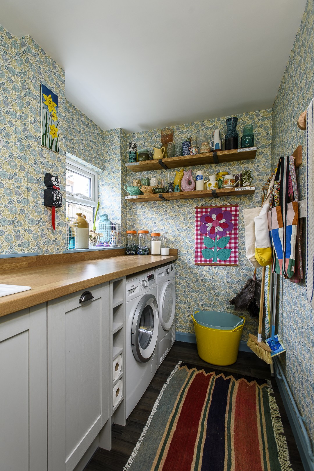 The utility room is papered with rolls of original Retro floral wallpaper that Katherine found online