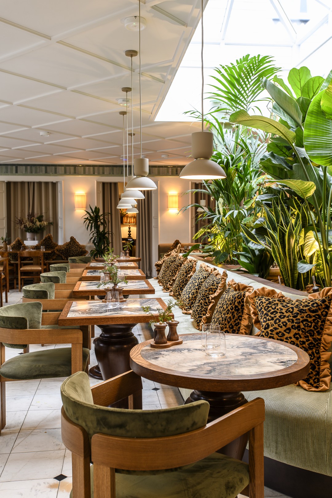 Layers of texture in shades of earth and green, and a focal-point of lush, tropical planting, create a sense of verdant luxury.