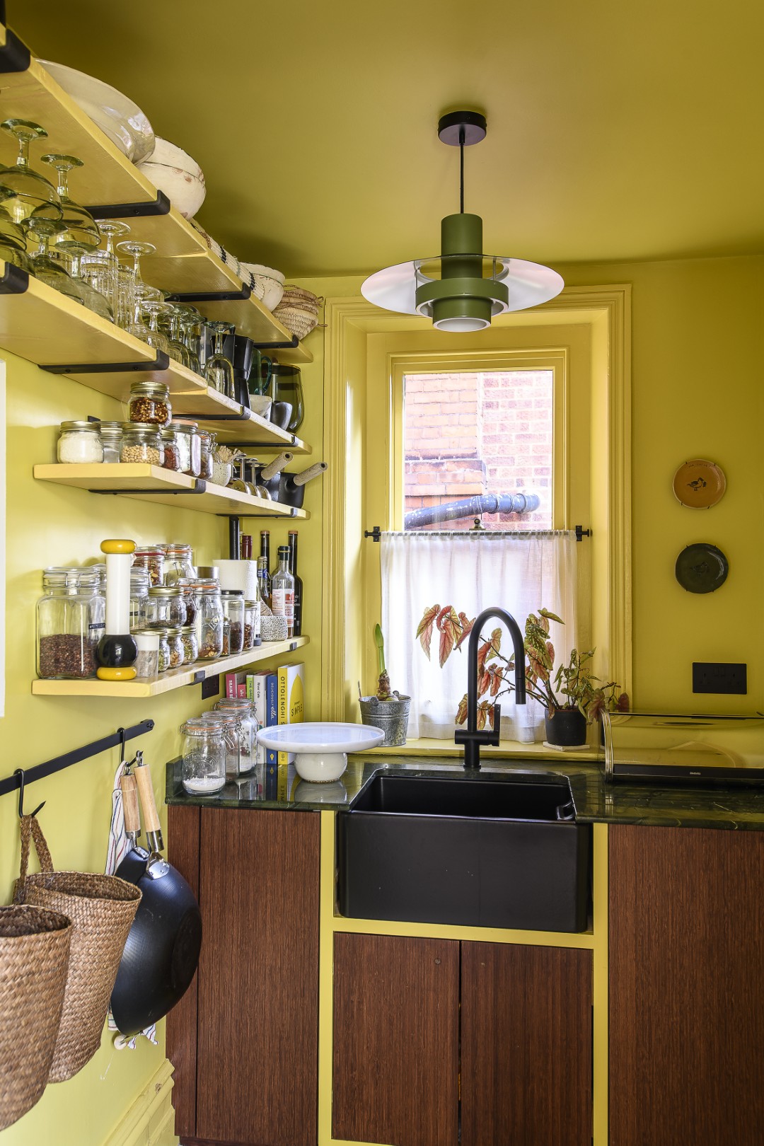 Through an archway off the kitchen, the pantry hasn’t been concealed behind a door, maintaining a sense of connection