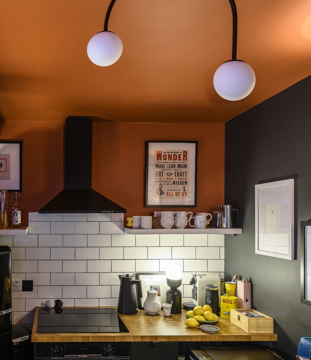 The kitchen is deep orange and black, set off by white splashback tiles. This fun space is where so many Dept of Joy items can be found. “My approach to interiors is not about filling your house with stuff, it’s about choosing pieces that make you smile when you walk past them,” Matt says