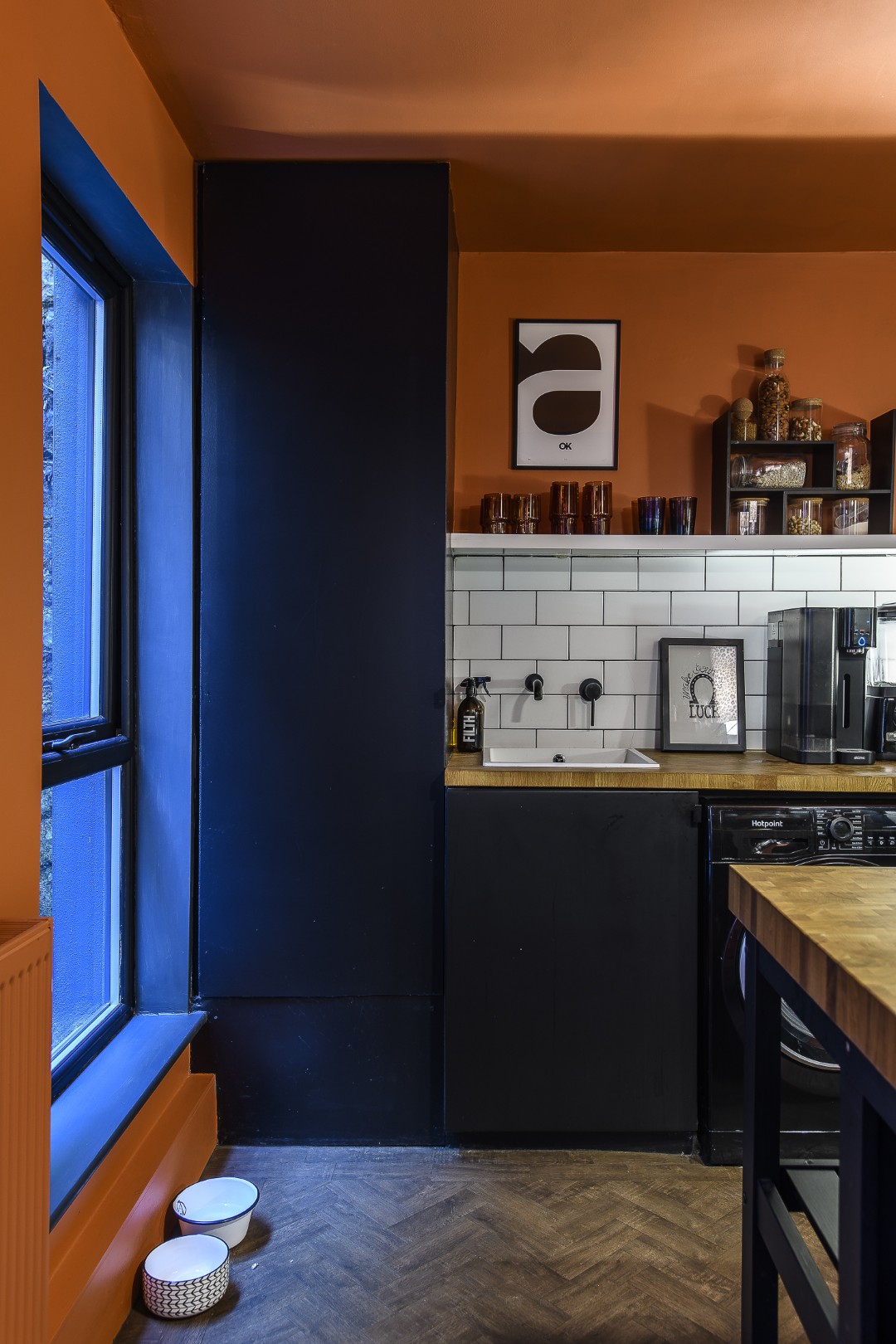 The kitchen is deep orange and black, set off by white splashback tiles. This fun space is where so many Dept of Joy items can be found. “My approach to interiors is not about filling your house with stuff, it’s about choosing pieces that make you smile when you walk past them,” Matt says
