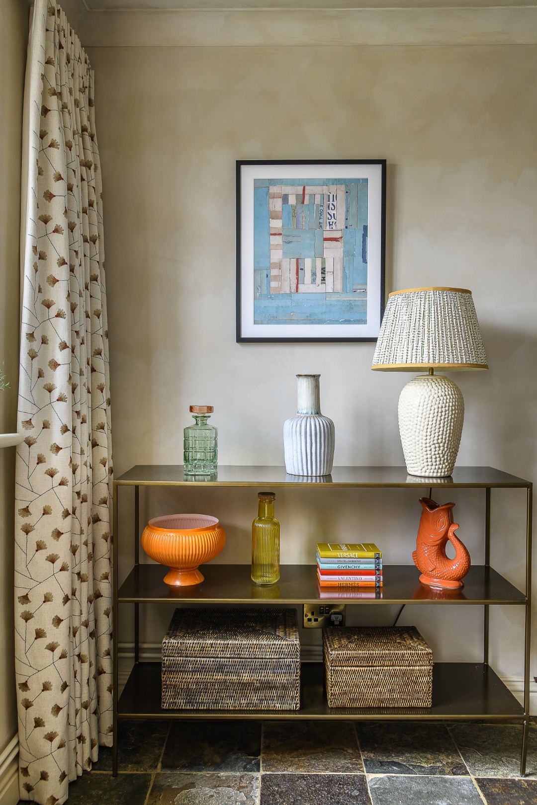 Splashes of orange punctuate earthy tones in the dining room