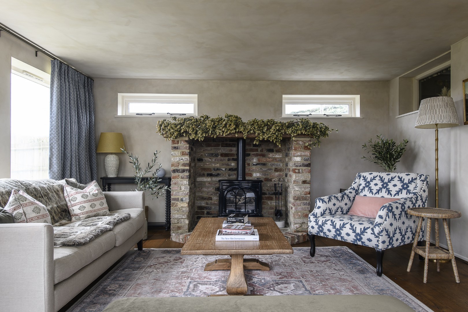 Steps from the sitting room lead down into the sun room, which overlooks the koi pond in the garden