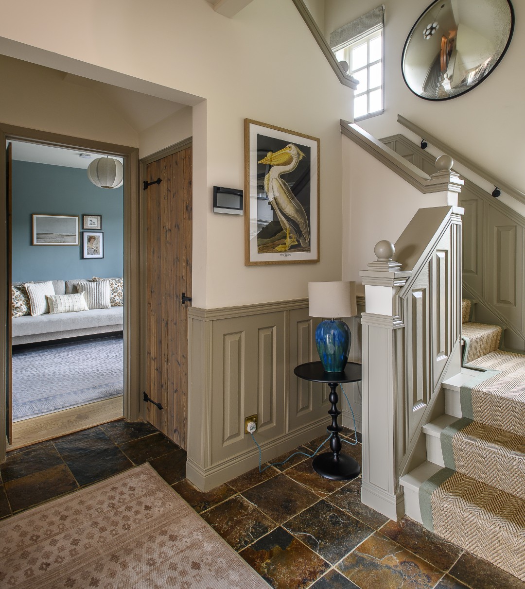 Winding up the centre of the house, the staircase has been decorated in neutral hues