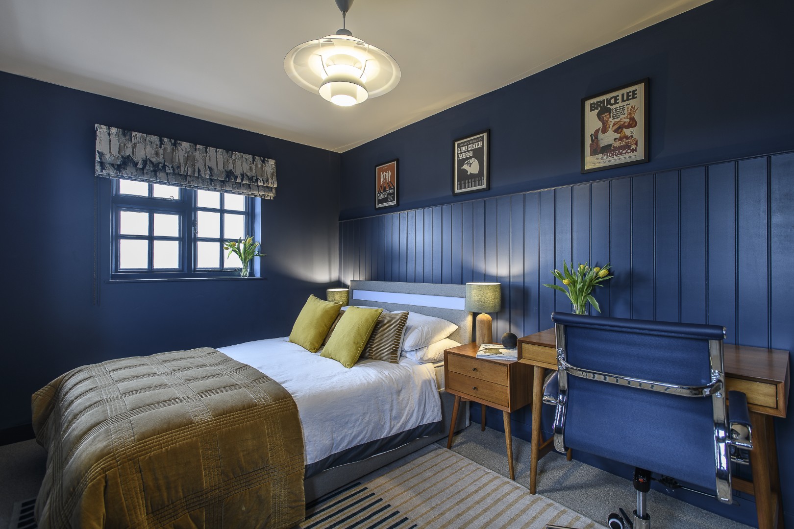 The couple’s son’s room is a navy blue retreat with desk space for studying
