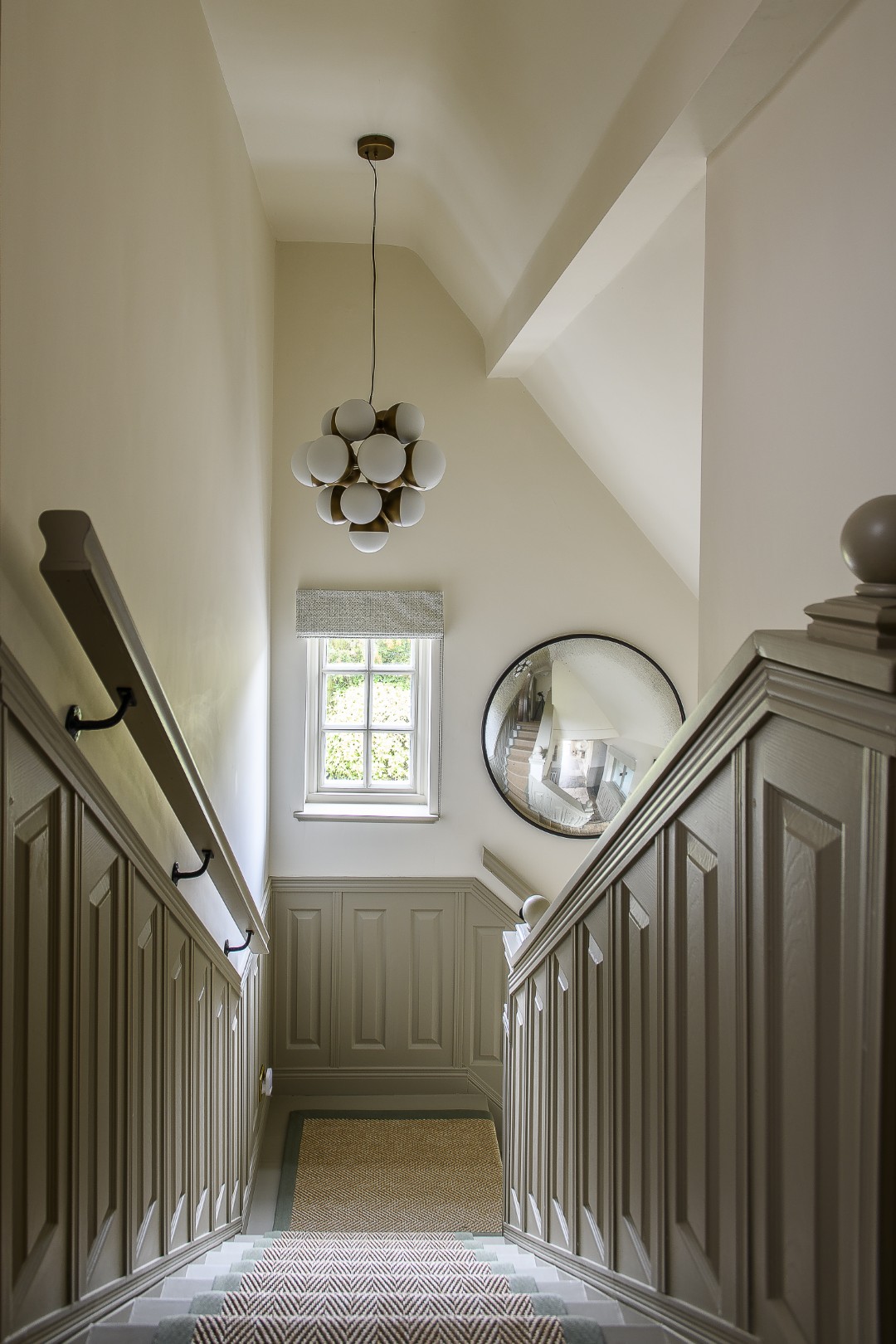 Winding up the centre of the house, the staircase has been decorated in neutral hues