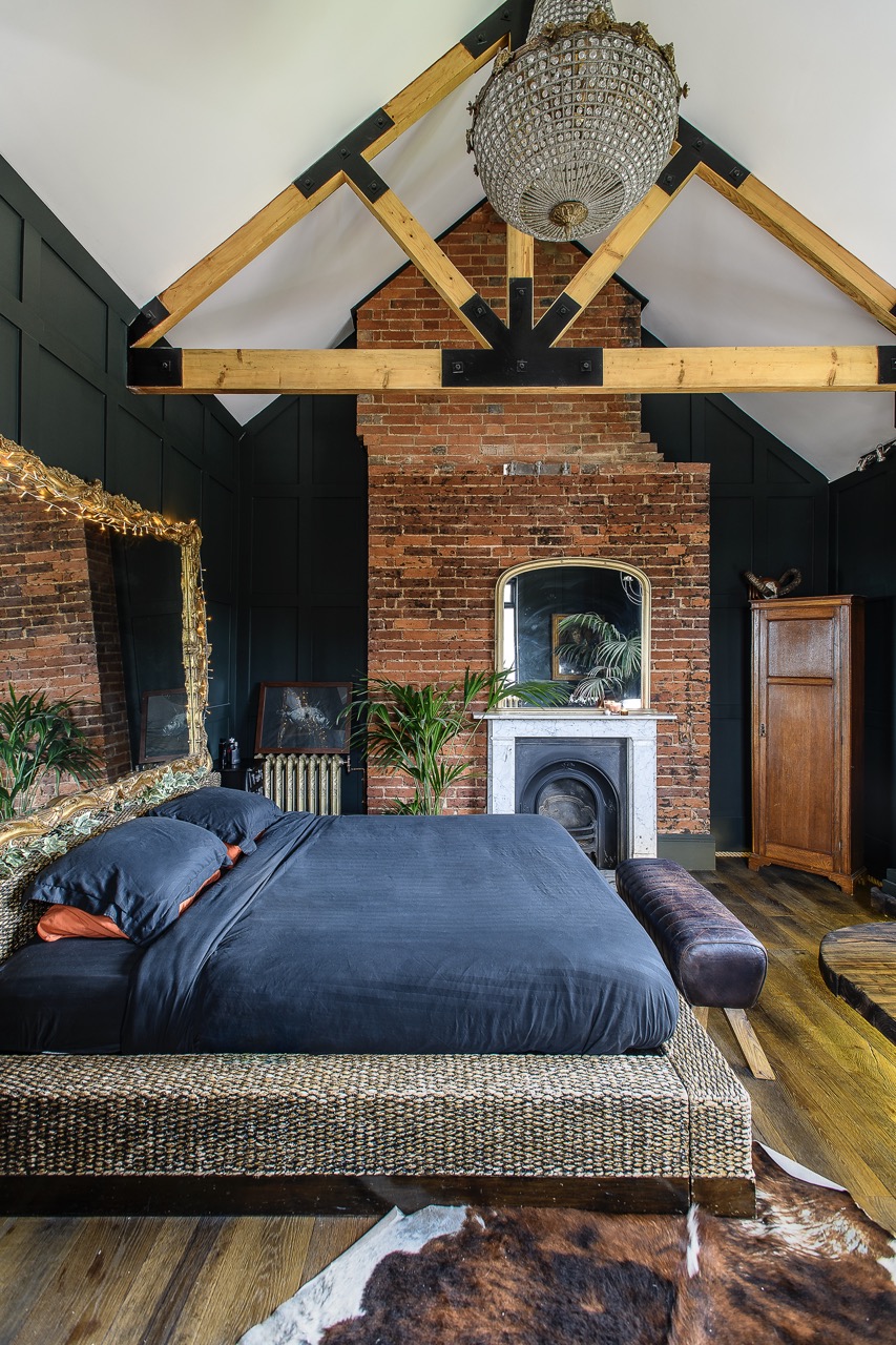 In the principal bedroom, Leigh removed the original ceiling to create soaring height.