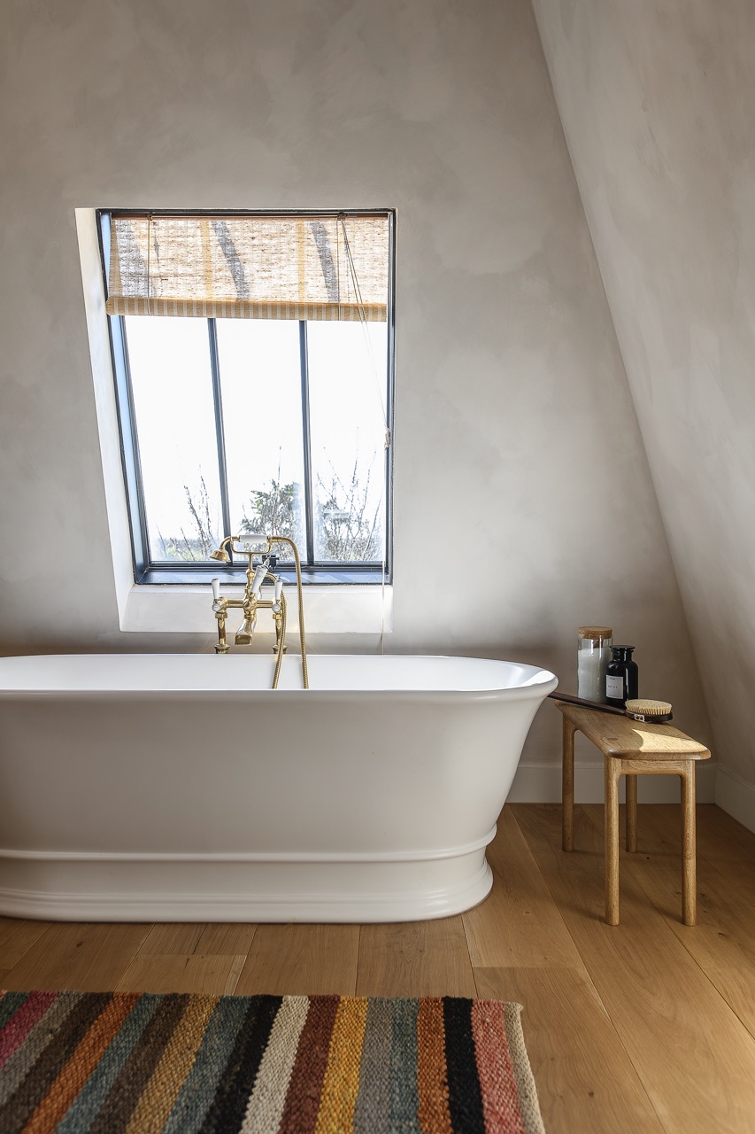 A guest bedroom and bathroom nestles into the space at the top of the house.