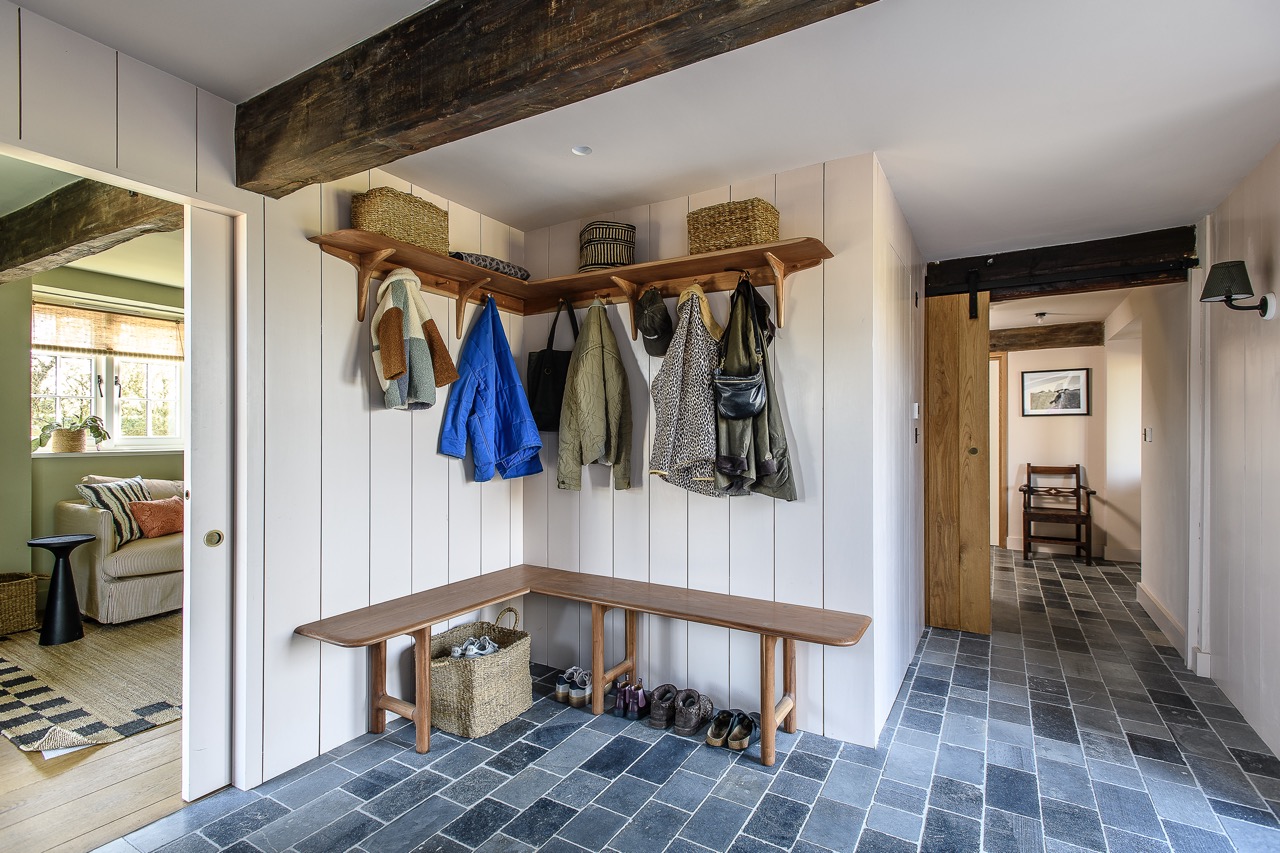 A pocket door in the entrance hall leads through to a small, cosy TV room.