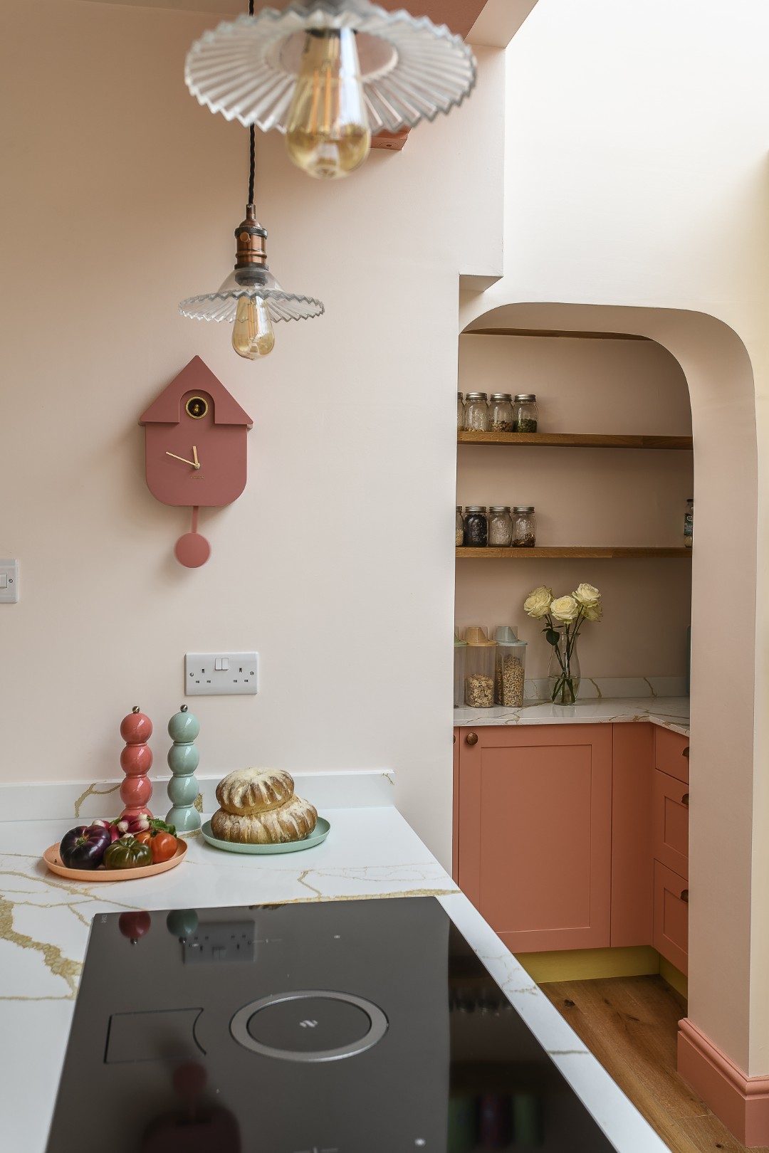 An archway leads to a useful, and very accessible pantry area.