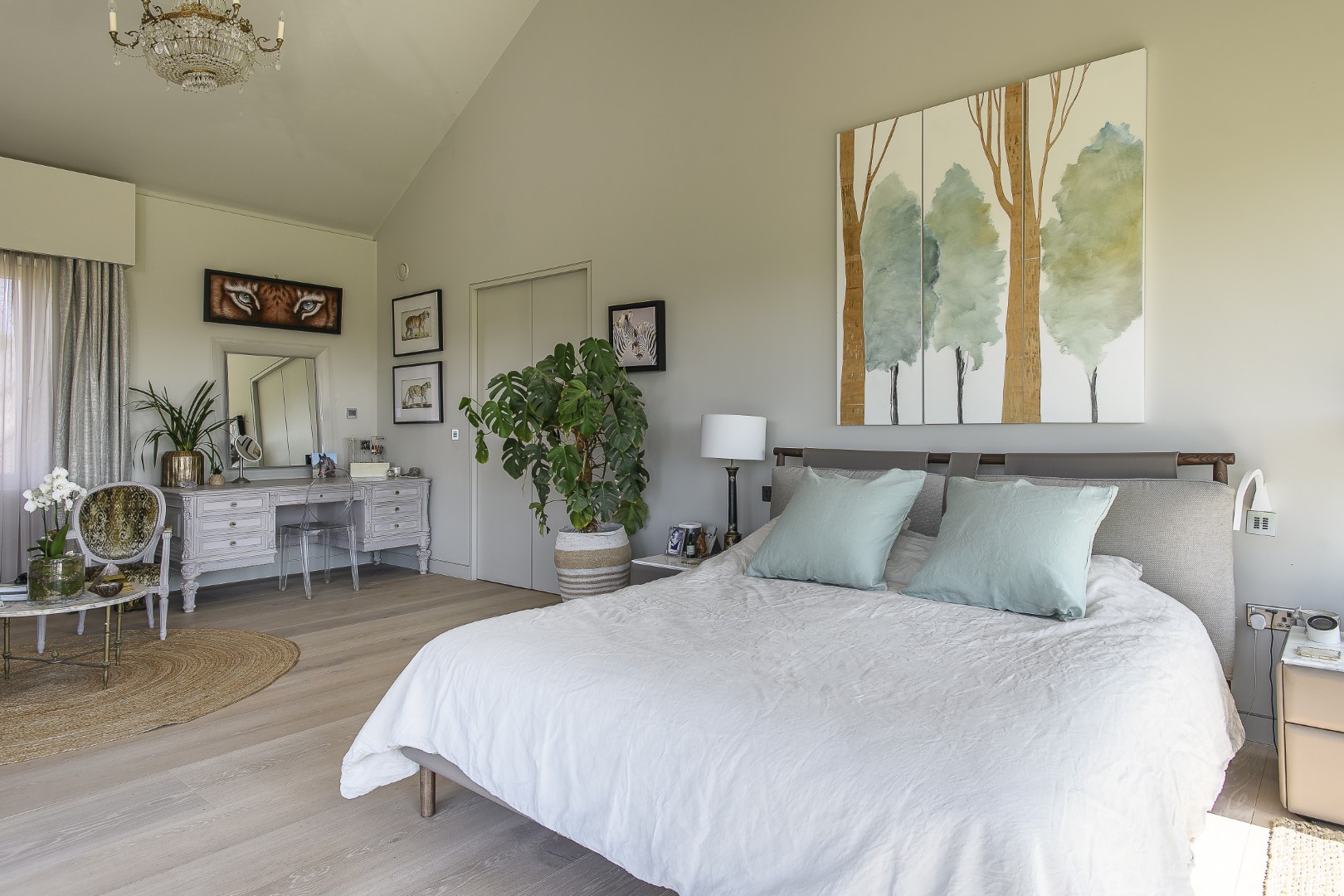 The principal bedroom, with its lofty ceiling, offers stunning views out over the surrounding landscape