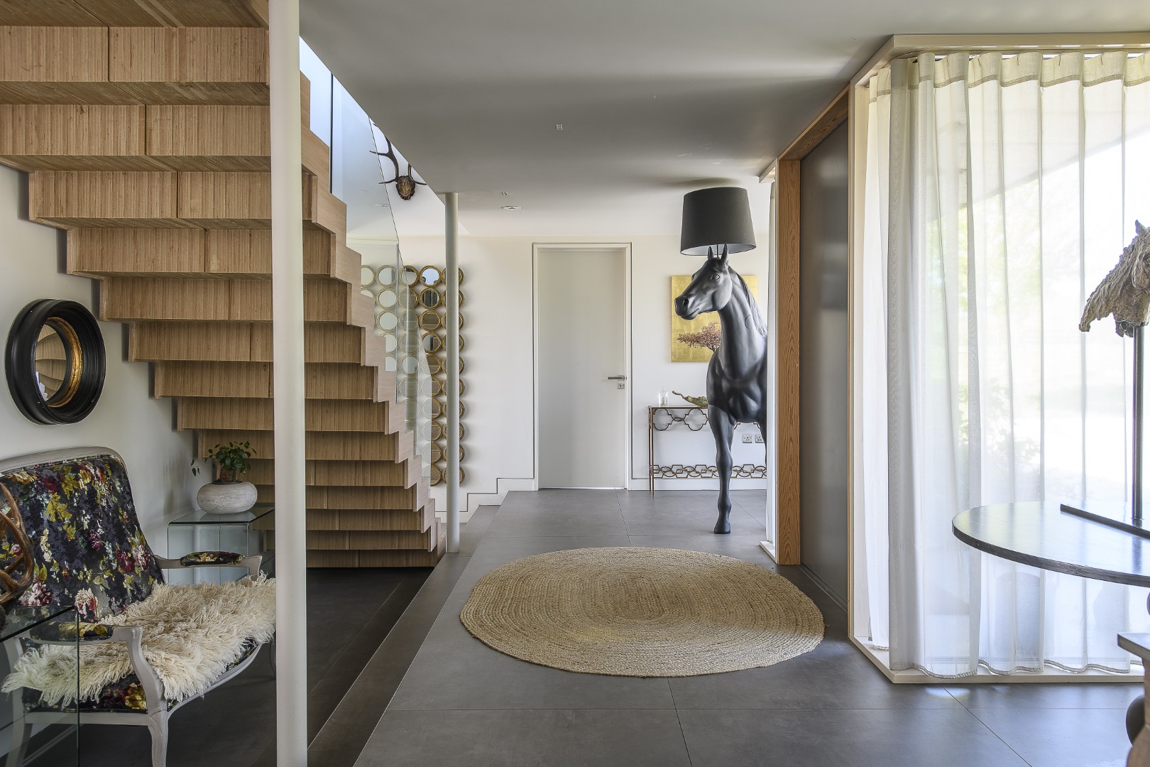 A lifesize horse lamp by Front, bought from Moooi, greets visitors in the entrance hall.