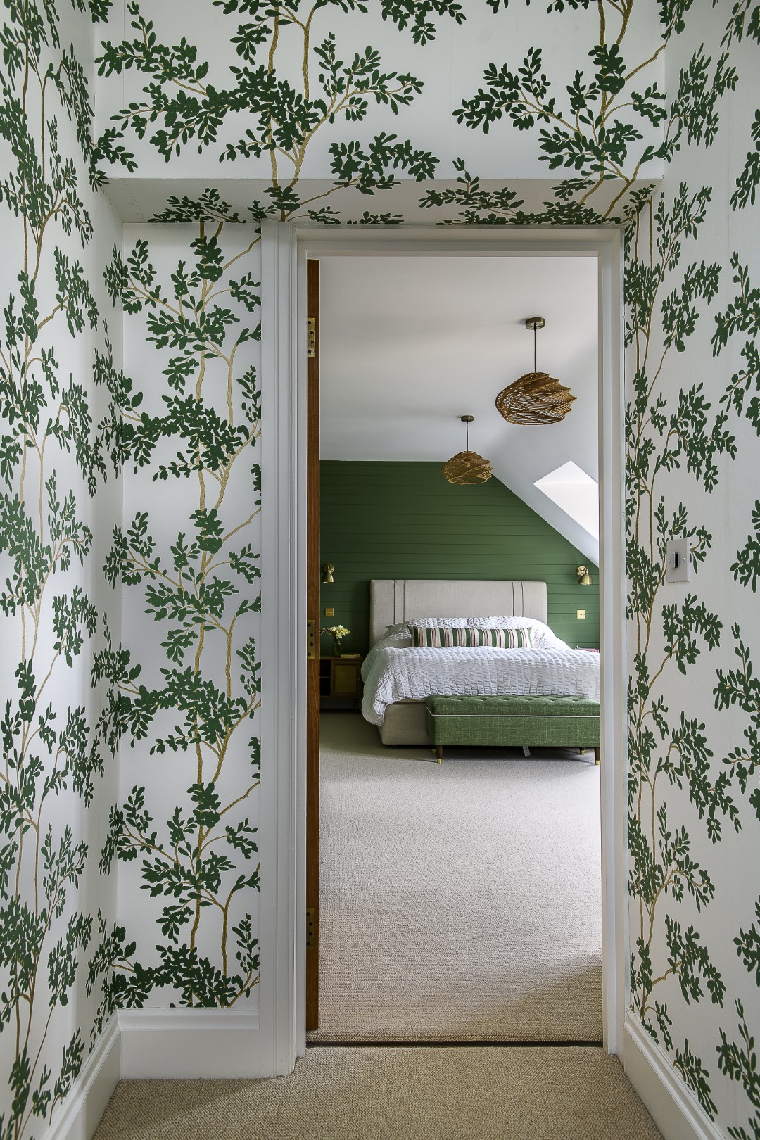 In the principal suite York’s Blooms Second Edition botanical wallpaper wraps the dressing room and extends through the corridor.