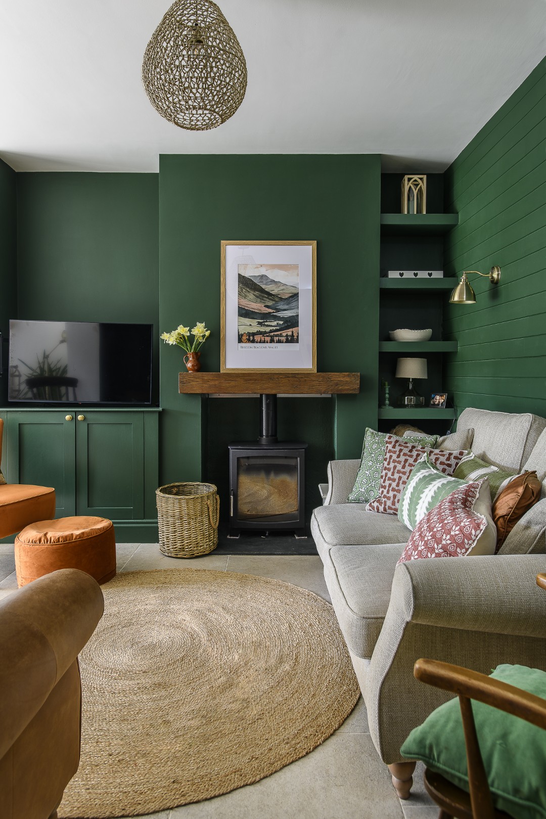 The forest green snug is tucked away around the corner from the kitchen, but is still very much a part of the open-plan living space which comprises the kitchen and dining areas