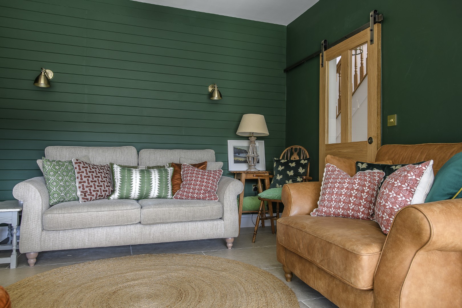 The forest green snug is tucked away around the corner from the kitchen, but is still very much a part of the open-plan living space which comprises the kitchen and dining areas