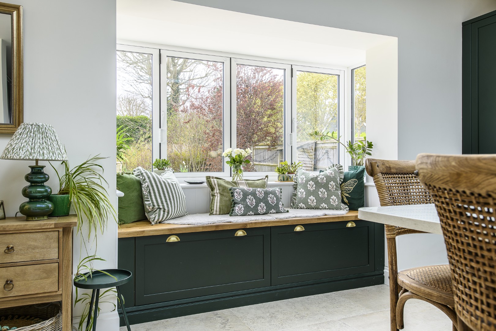 Storage doubles up as seating in the kitchen, where deep drawers serve as a handy place to perch looking out into the garden