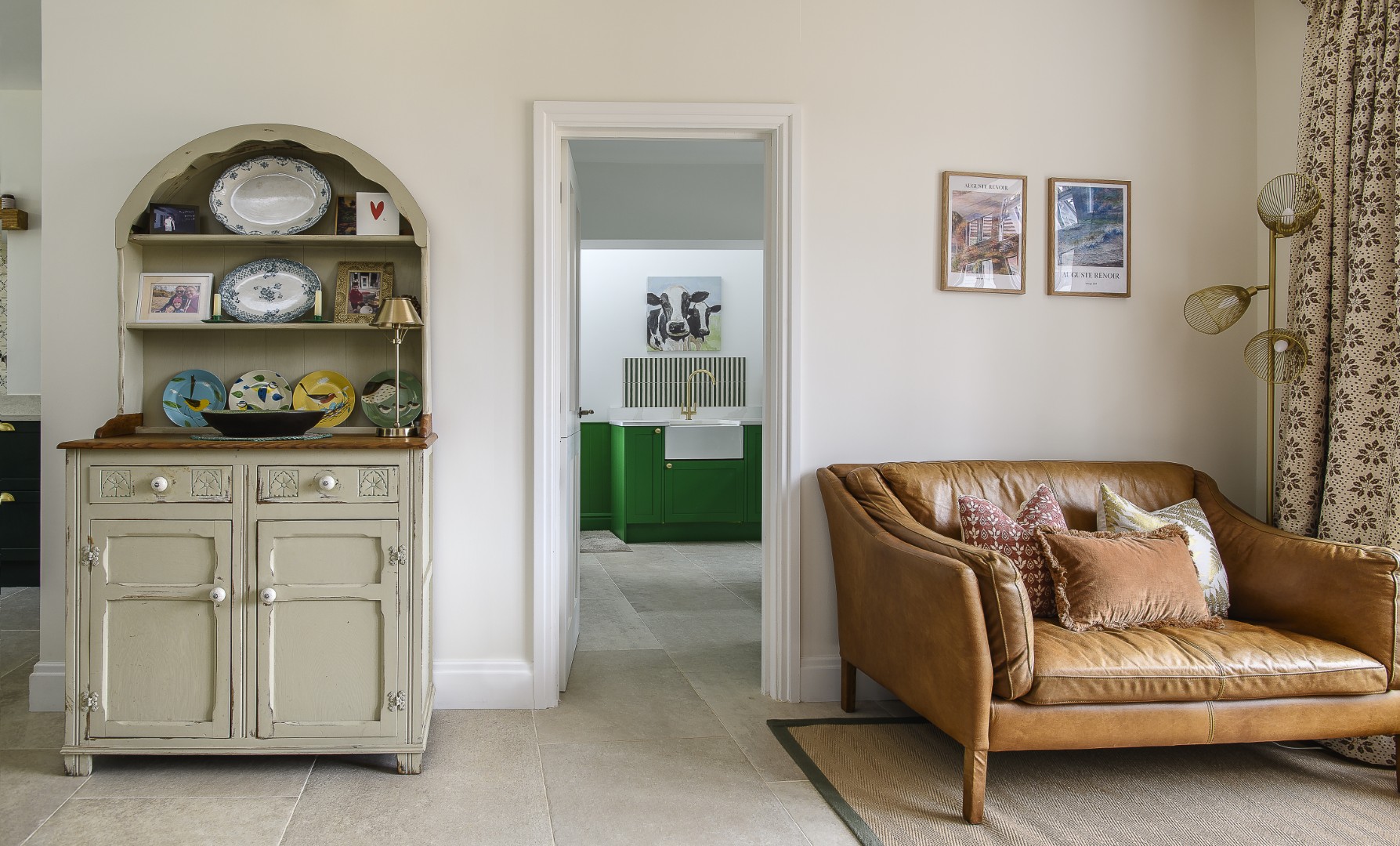 The utility room is tucked off the main living area, its lovely bright green cabinetry and striped splashback ensuring it doesn’t fade into insignificance
